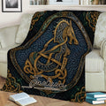 Norse knotwork Viking blanket draped across a sofa, showcasing bold dark artwork with ornate gold details