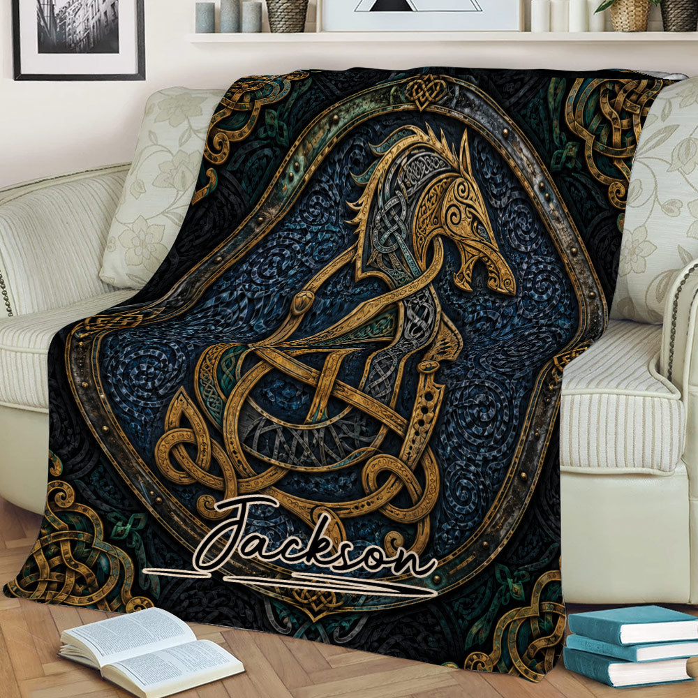 Norse knotwork Viking blanket draped across a sofa, showcasing bold dark artwork with ornate gold details
