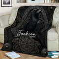 Close view of a Viking raven throw blanket with dark runic-inspired artwork on a sofa
