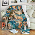 Surfing throw blanket draped over a sofa with tropical beach, surfboard, wave, and sea turtle artwork