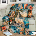 Tropical surfing throw blanket styled on an armchair with ocean waves, surfboards, flowers, and shells