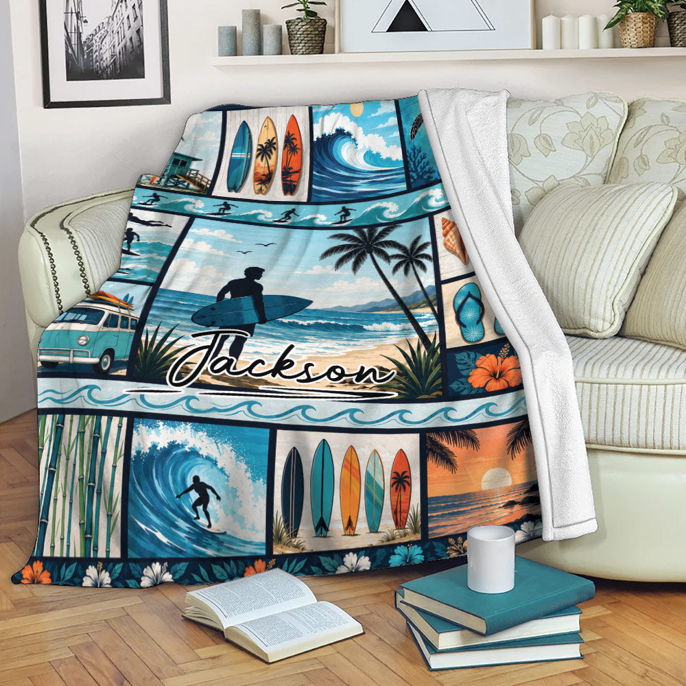 Surfing blanket draped over a sofa showing ocean waves, surfboards, palm trees, and beach scenes