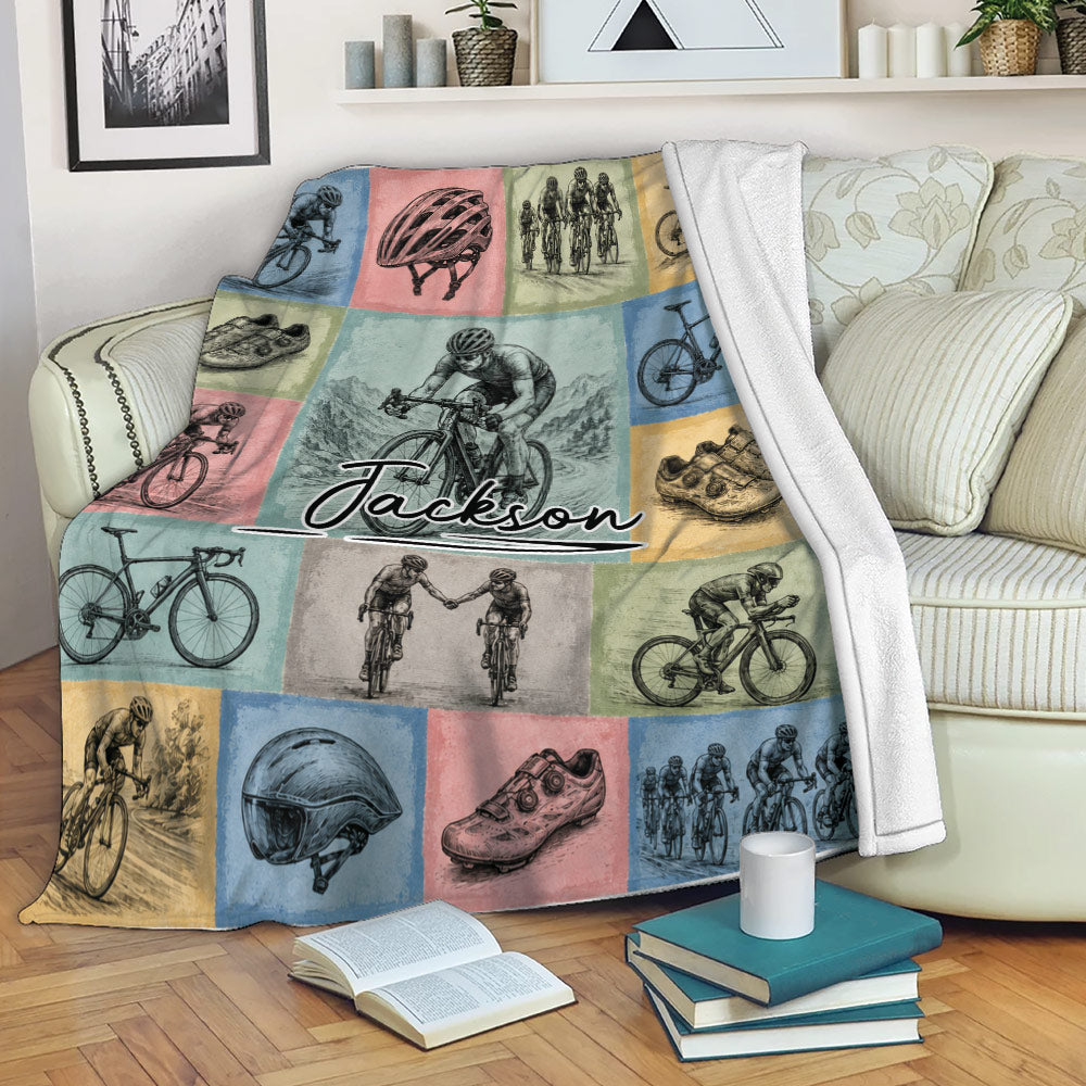 Bicycle throw blanket styled on a sofa with colorful vintage cycling panels and rider illustrations