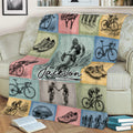 Close view of bicycle throw blanket featuring cyclists, road bikes, helmets, shoes, and mountain riding artwork