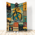 Vintage bicycle collage blanket displayed with cycling scenes, bike parts, and an illustrated rider design