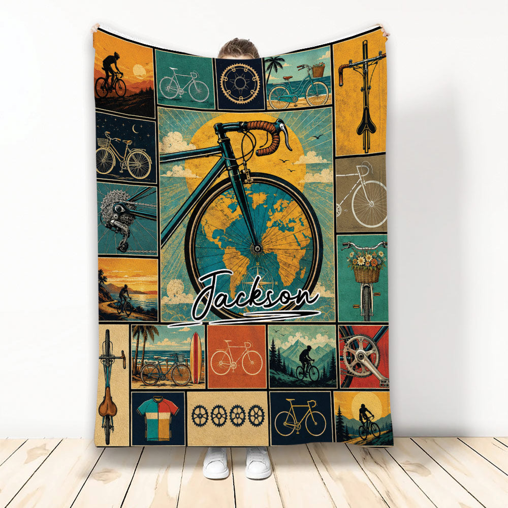 Vintage bicycle collage blanket displayed with cycling scenes, bike parts, and an illustrated rider design