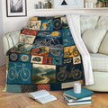 Bicycle throw blanket draped over a sofa with cycling collage artwork in blue, gold, and red