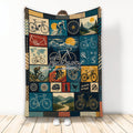 Bicycle blanket with vintage-inspired cycling collage, mountain scenes, bike parts, and rider artwork