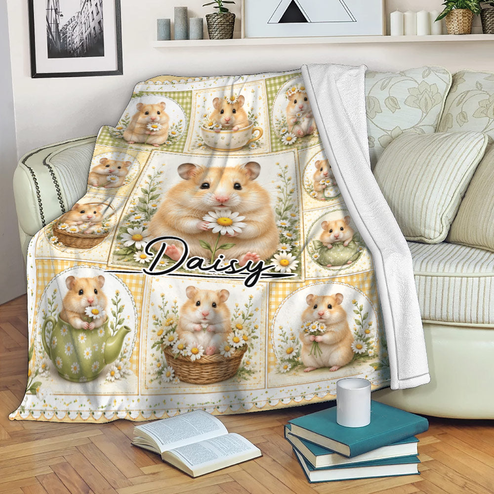 Hamster blanket draped over a sofa, showing a floral collage of hamsters with daisies