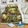 Frog throw blanket draped over a sofa with woodland scenes, flowers, mushrooms, and green frogs