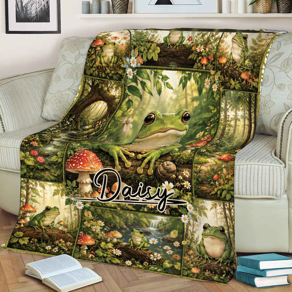 Woodland frog blanket displayed on a sofa with forest scenery, wildflowers, mushrooms, and frog artwork