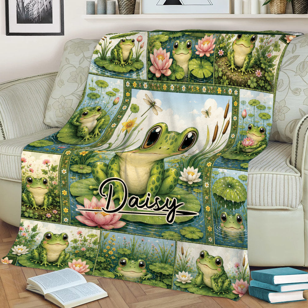 Frog throw blanket displayed on a couch with a large central frog surrounded by pond plants and flowers