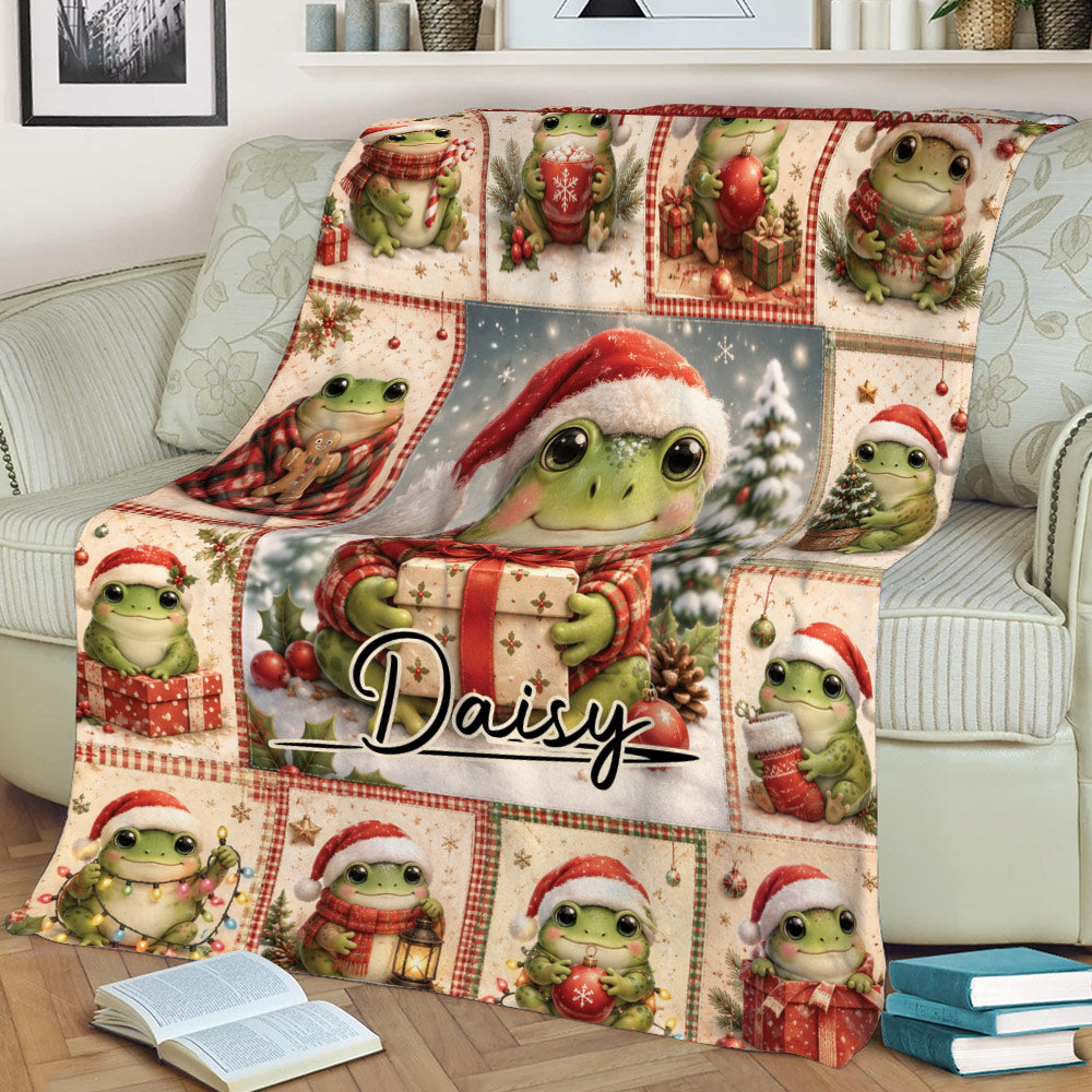 Christmas frog blanket shown on a couch with Santa hats, ornaments, gifts, and cozy holiday artwork