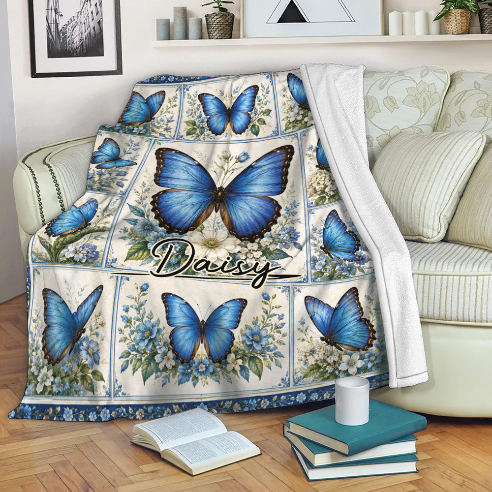 Blue butterfly and floral throw blanket draped over a sofa in a cozy living room