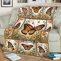 Floral butterfly blanket displayed on a sofa with detailed orange butterfly illustrations