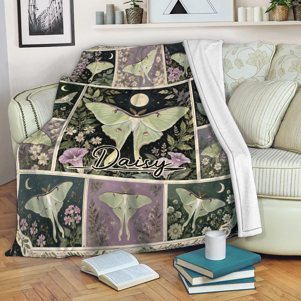 Butterfly throw blanket draped over a sofa with botanical flowers, moon motifs, and a cozy reading setting