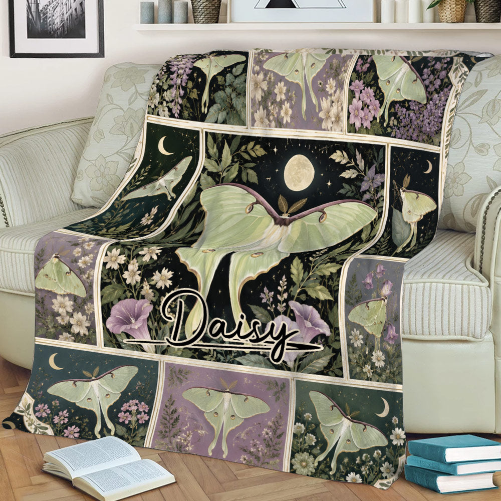 Floral butterfly blanket styled across a sofa, featuring green winged insects and a dark enchanted garden theme