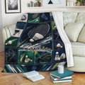 Badminton blanket displayed over a sofa with racket and shuttlecock collage artwork in a cozy living room