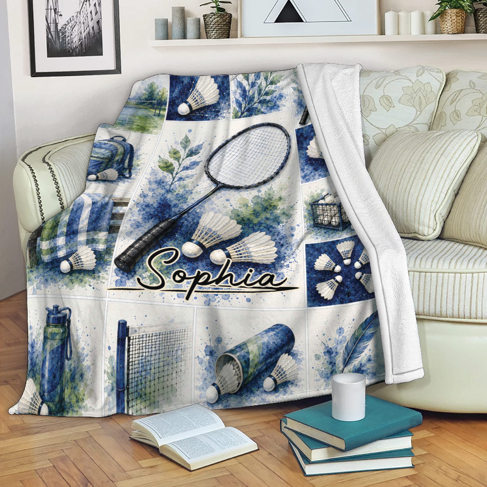 Badminton throw blanket draped over a sofa with watercolor racket, shuttlecock, court, and gear artwork