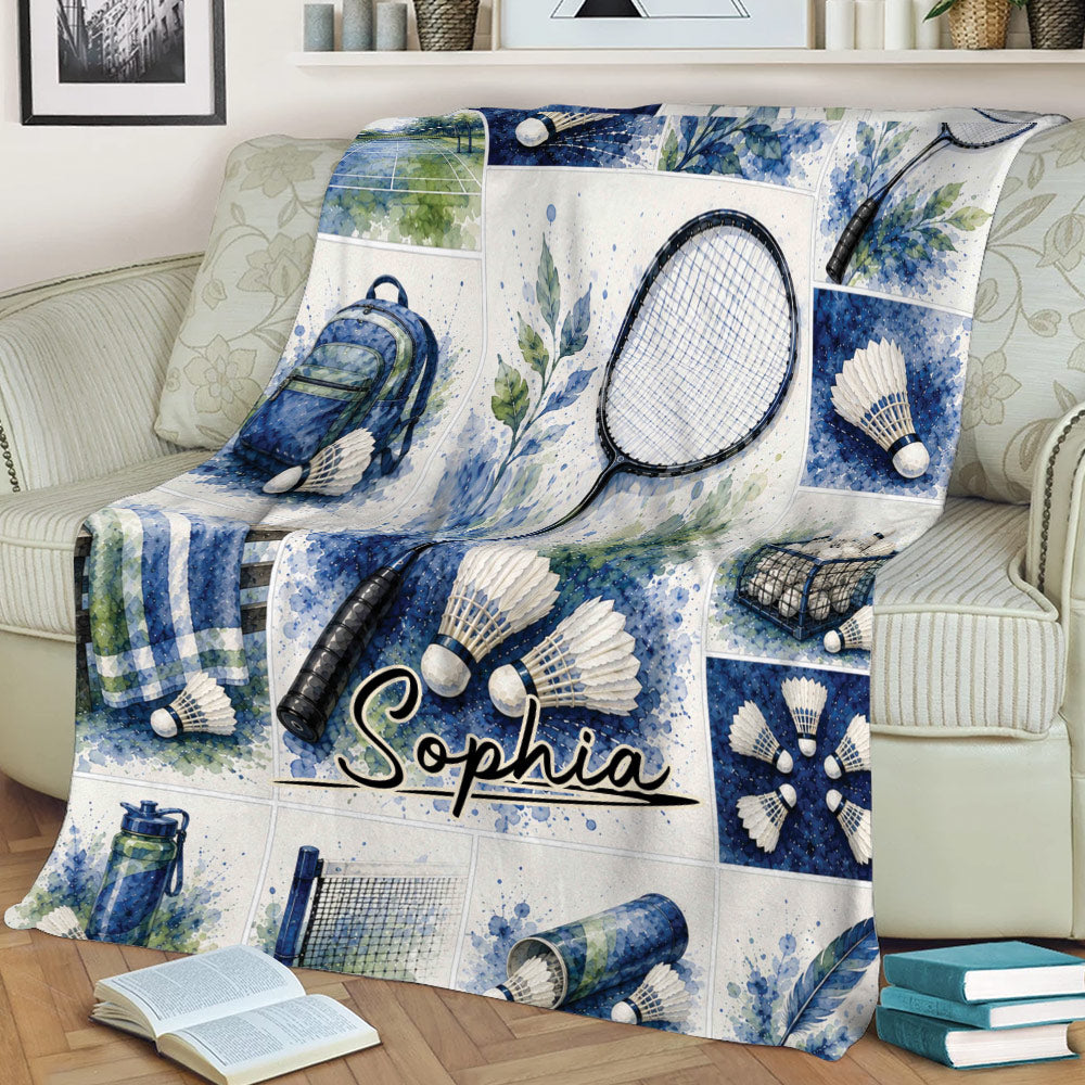 Close view of a badminton blanket on a sofa featuring watercolor racket, shuttlecock, net, and court designs