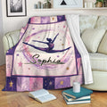 Gymnastics blanket displayed on a sofa with colorful star borders and a leaping gymnast design