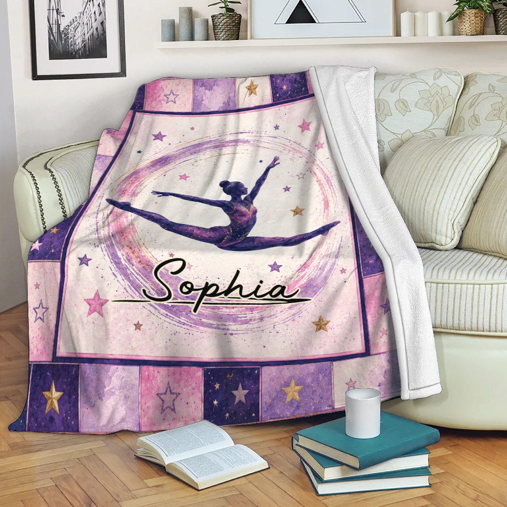 Gymnastics blanket displayed on a sofa with colorful star borders and a leaping gymnast design