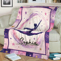 Starry gymnastics throw blanket draped over a couch, featuring a dynamic gymnast in a split leap