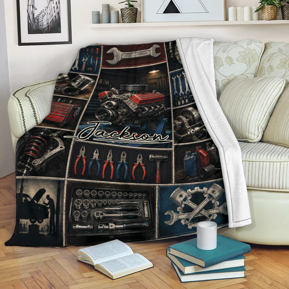 Mechanic throw blanket draped over a sofa with engine, tool chest, wrenches, and auto repair artwork