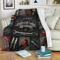 Mechanic throw blanket displayed on a sofa with an automotive engine and tool collage design