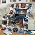 Close view of mechanic blanket featuring a classic truck, repair tools, engine parts, and garage scenes
