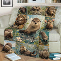 Close view of an otter throw blanket with detailed river otter artwork arranged in a scenic collage