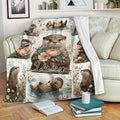 Floral otter throw blanket draped over a sofa with playful pond and flower scenes