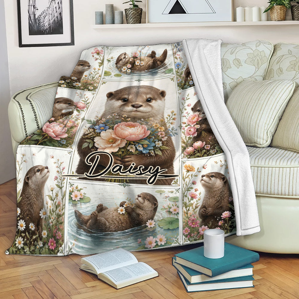 Floral otter throw blanket draped over a sofa with playful pond and flower scenes