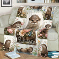 Close lifestyle view of an otter blanket with colorful flowers and woodland wildlife artwork
