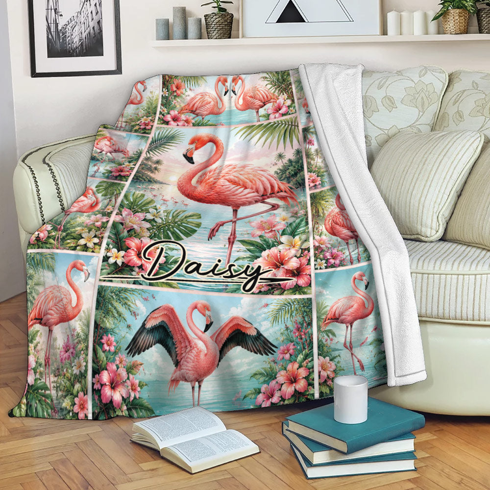 Flamingo throw blanket draped over a sofa with tropical flowers and coastal artwork