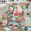 Close lifestyle view of a tropical flamingo blanket spread across a sofa with floral details