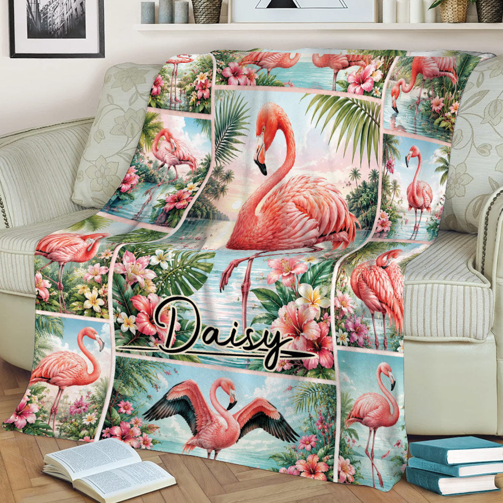 Close lifestyle view of a tropical flamingo blanket spread across a sofa with floral details