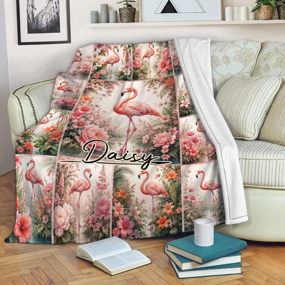Flamingo throw blanket displayed on a sofa with pink floral artwork and tropical botanical details