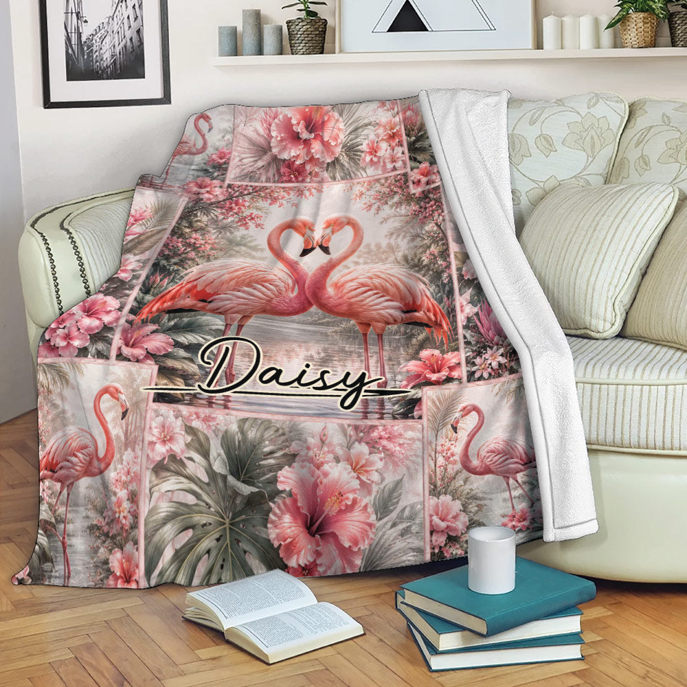 Flamingo throw blanket draped over a sofa with tropical floral artwork