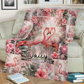 Tropical flamingo blanket displayed on a sofa with paired flamingos and hibiscus flowers