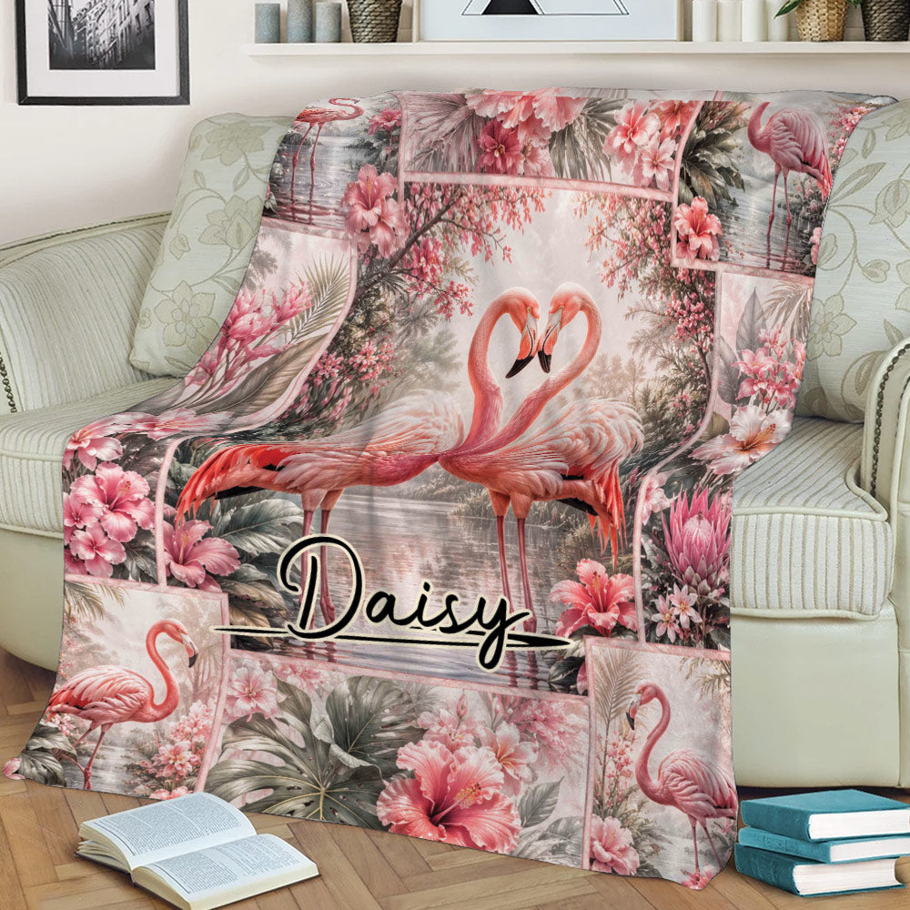 Tropical flamingo blanket displayed on a sofa with paired flamingos and hibiscus flowers