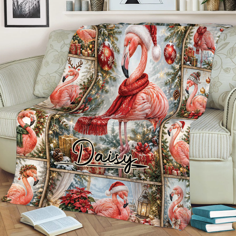 Christmas flamingo throw blanket displayed on a couch with snowy scenery, poinsettias, presents, and ornaments