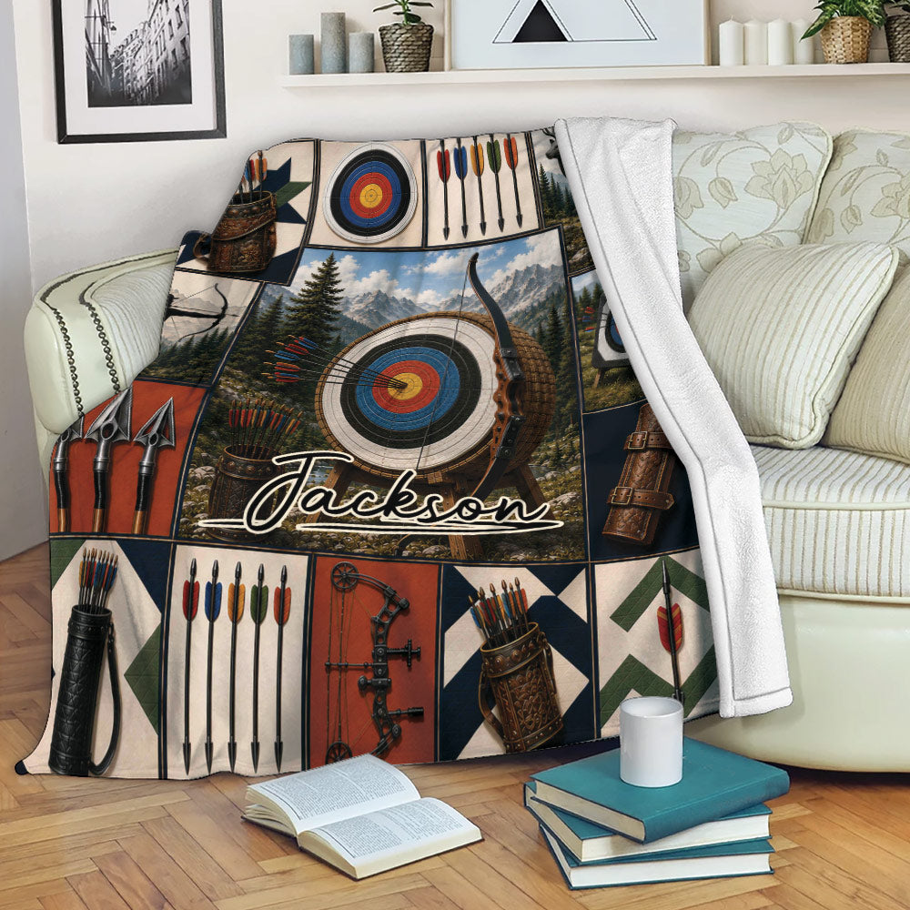 Archery throw blanket displayed on a sofa with colorful targets, bows, arrows, quivers, and mountain artwork