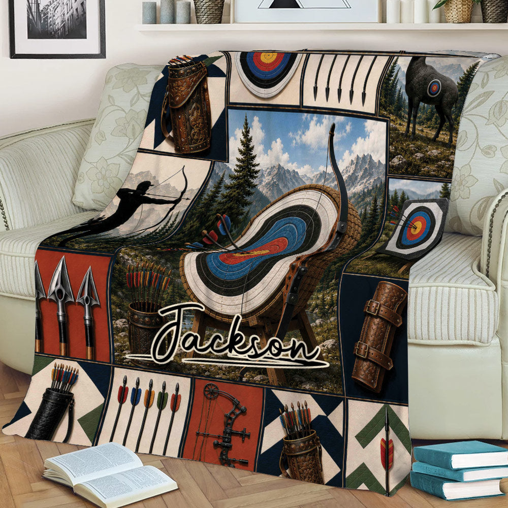 Archery blanket draped over a couch with target artwork, bow and arrow illustrations, quivers, and forest scenery