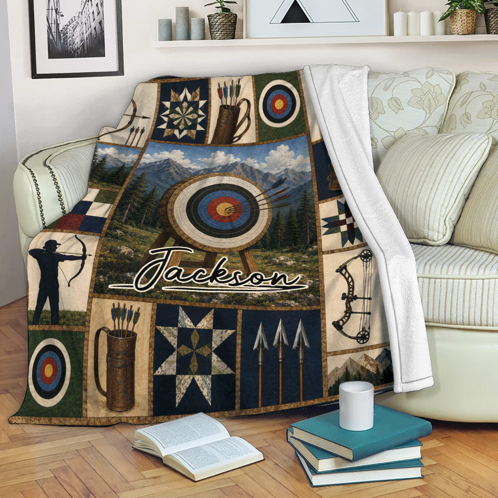 Custom archery blanket displayed on a sofa with bows, arrows, targets, and mountain landscape artwork