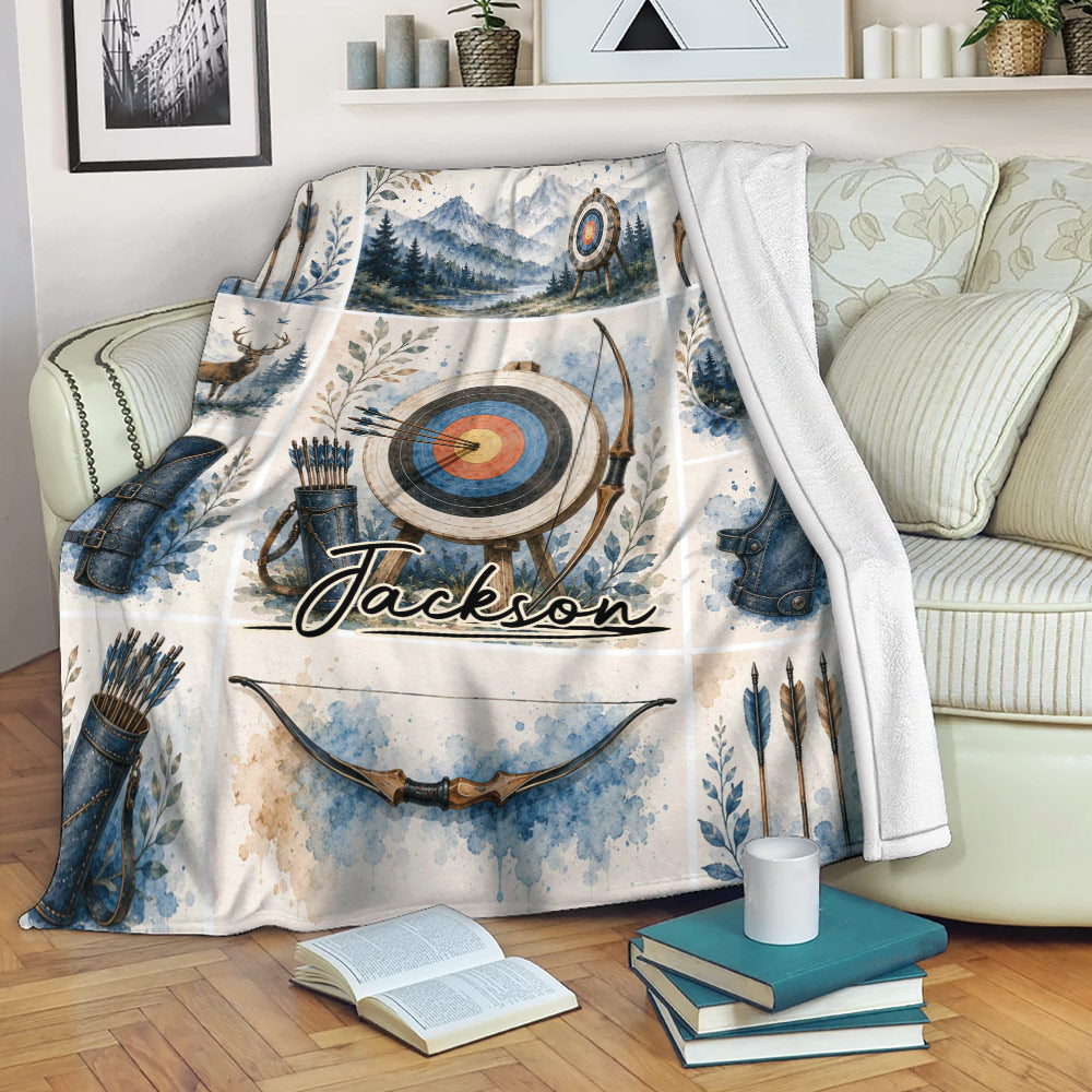 Archery throw blanket draped over a sofa with bow, arrow, target, and woodland artwork