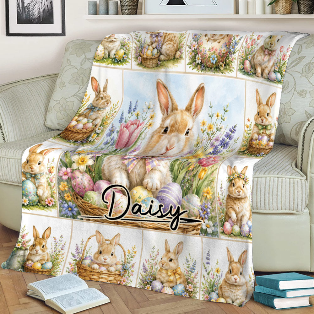 Rabbit throw blanket draped over a sofa, featuring Easter bunnies, baskets, eggs, and flowers