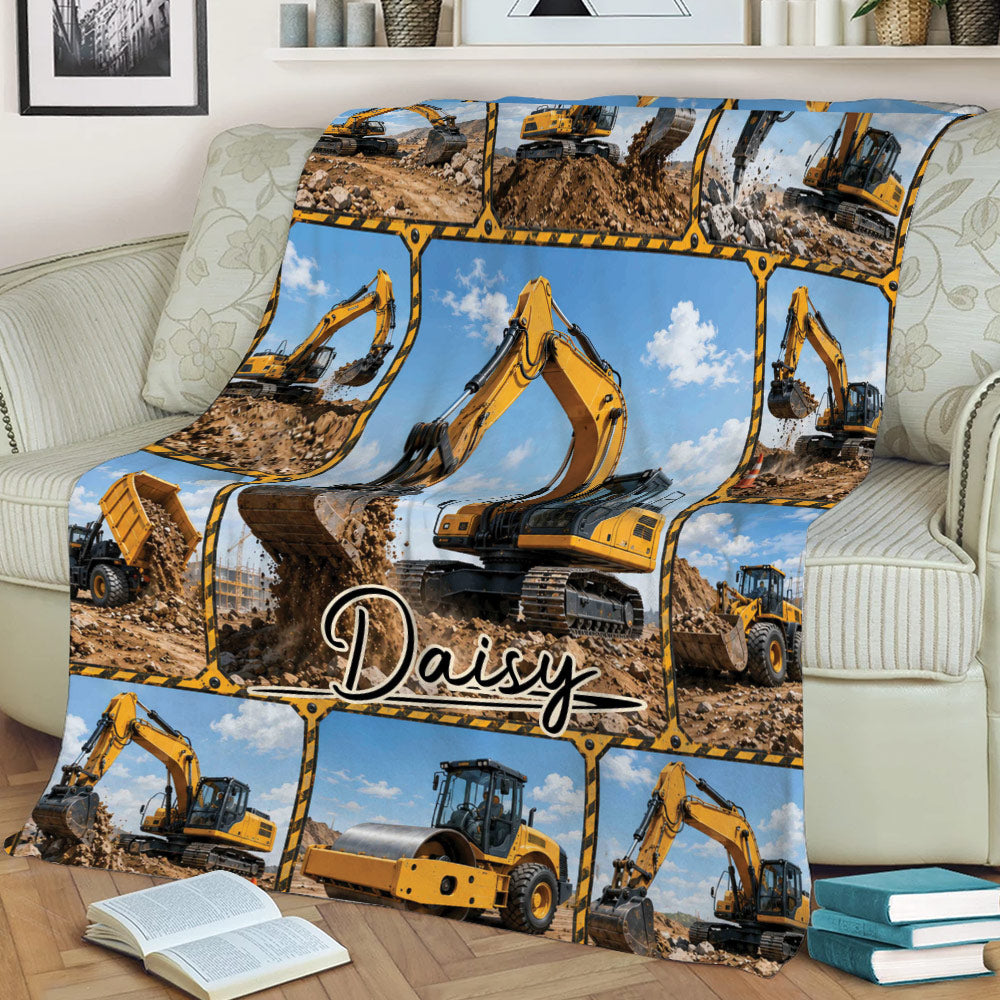 Construction excavator blanket draped across a sofa with yellow machinery collage artwork