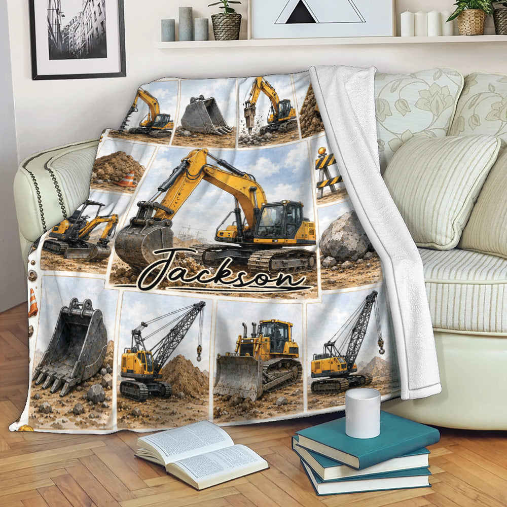 Excavator throw blanket draped over a sofa with yellow construction equipment artwork