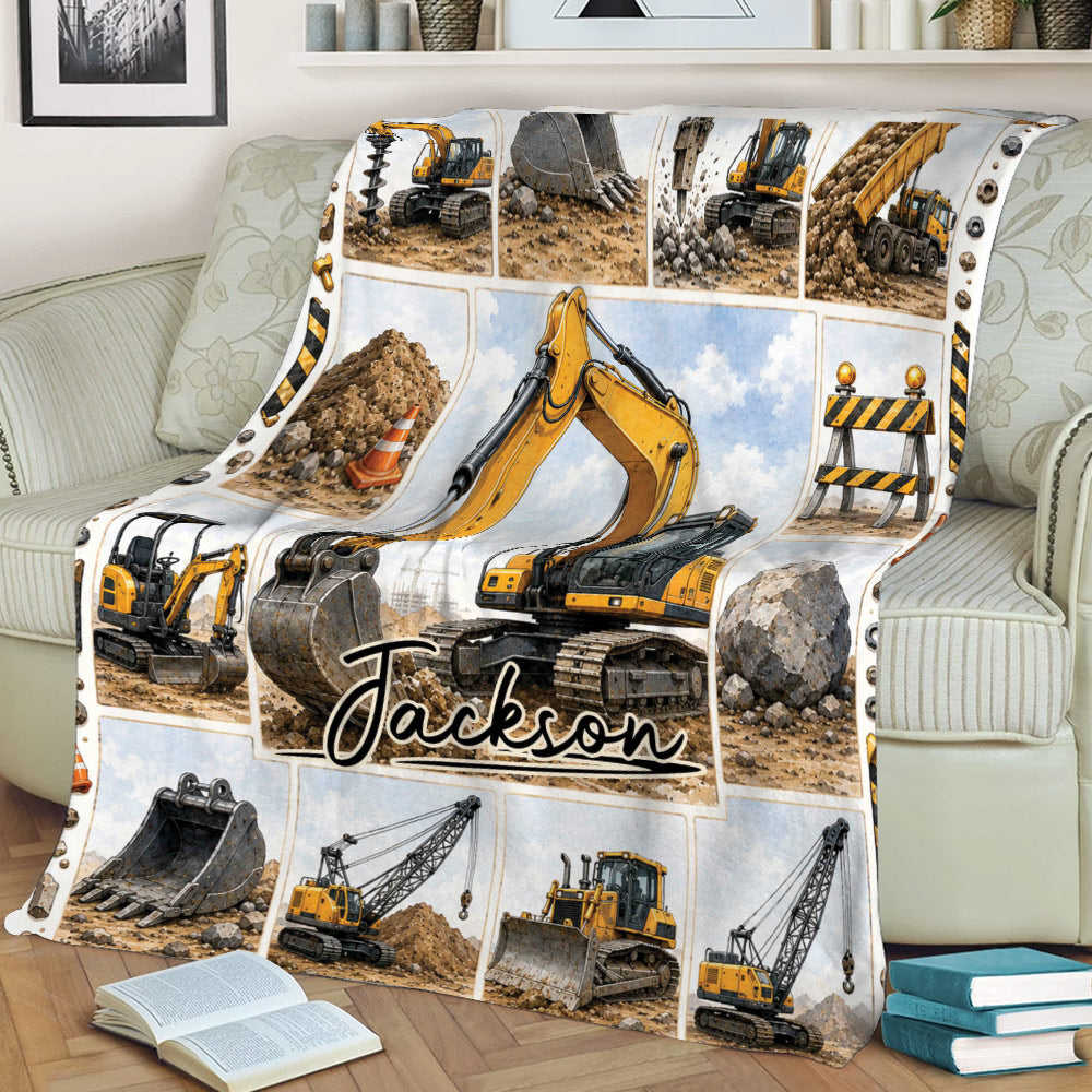 Construction-themed excavator blanket displayed across a sofa with heavy machinery collage artwork
